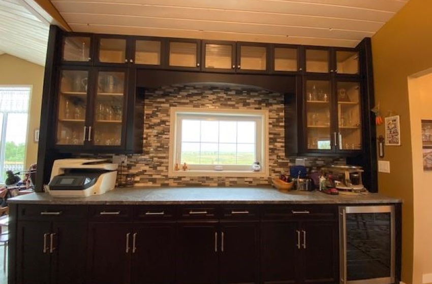 Bar fridge, upper & lower cabinetry on South kitchen wall