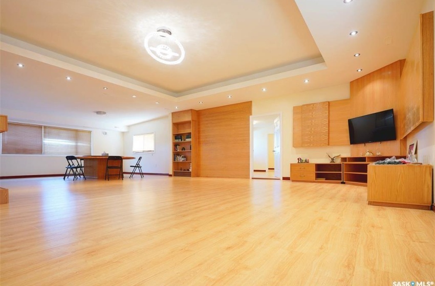 Living room featuring a tray ceiling and light hardwood / wood-style flooring