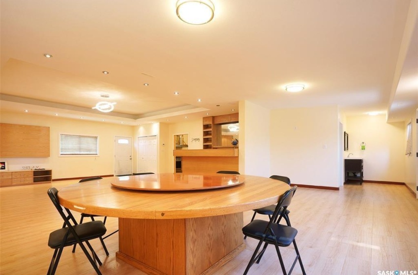 Kitchen with a tray ceiling and light wood-type flooring