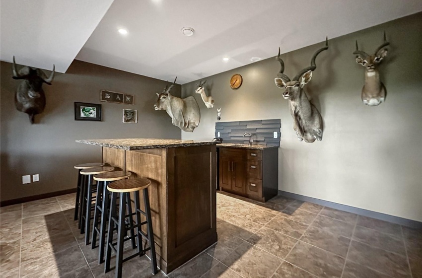 basement entertainment area with wet bar