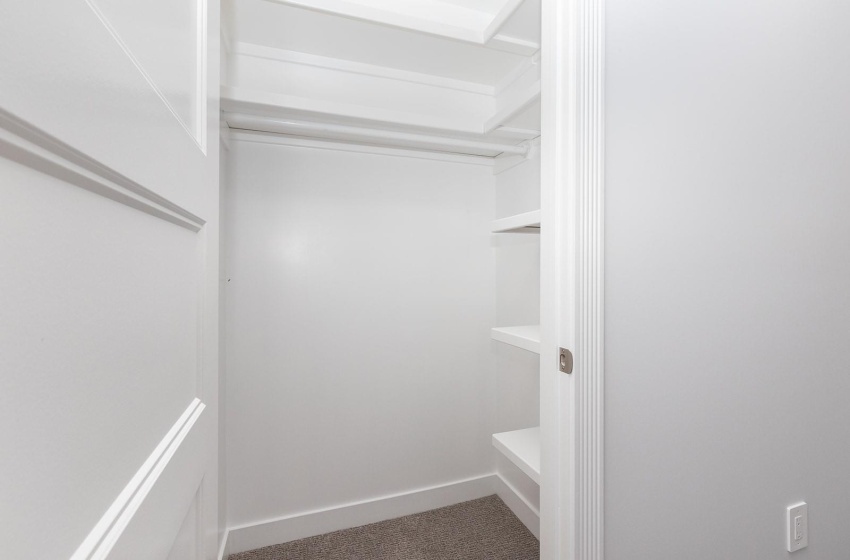 Secondary bedroom  walk-in closet with shelving