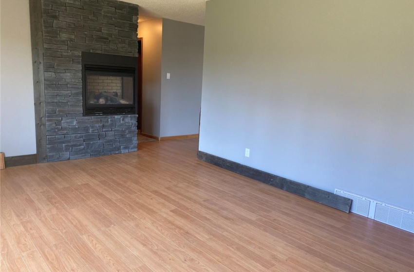 Cozy corner gas fireplace enjoyed by living room & dinette.