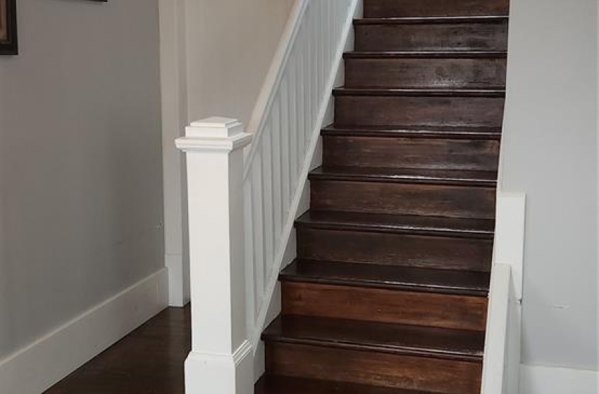 Stairway featuring dark hardwood / wood-style floors