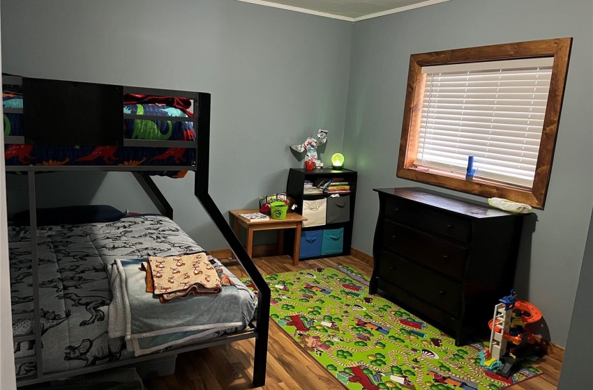 Bedroom featuring wood-type flooring and ornamental molding