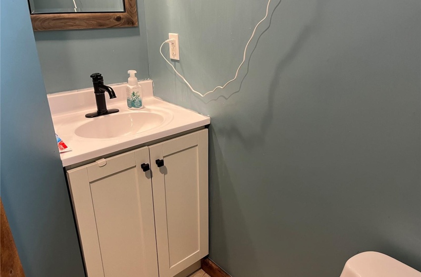 Bathroom featuring vanity, toilet, and tile flooring