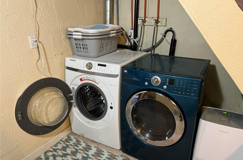 Laundry area featuring washer hookup and washing machine and clothes dryer