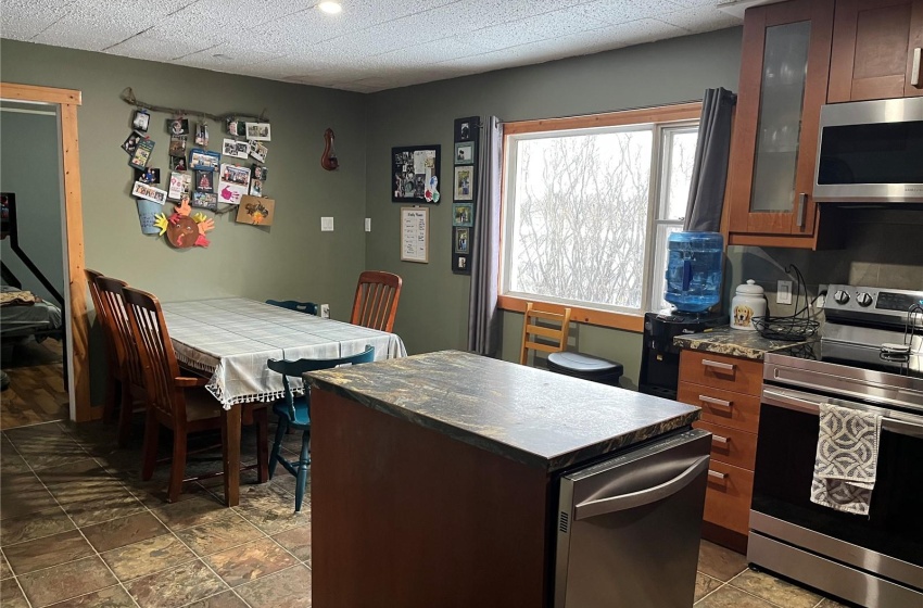 Kitchen featuring stainless steel appliances, a kitchen island, dark floors,