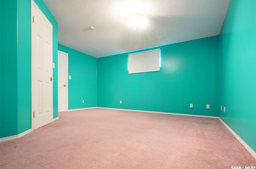 Carpeted empty room with a textured ceiling