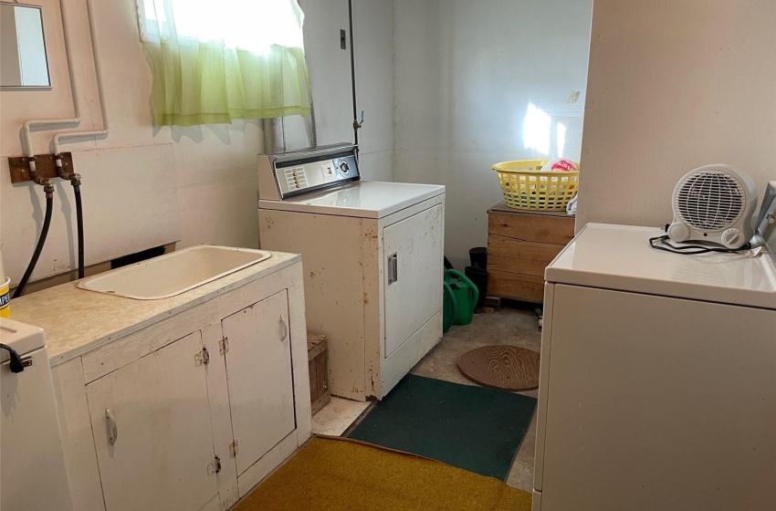 Clothes washing area with cabinets and washing machine and dryer