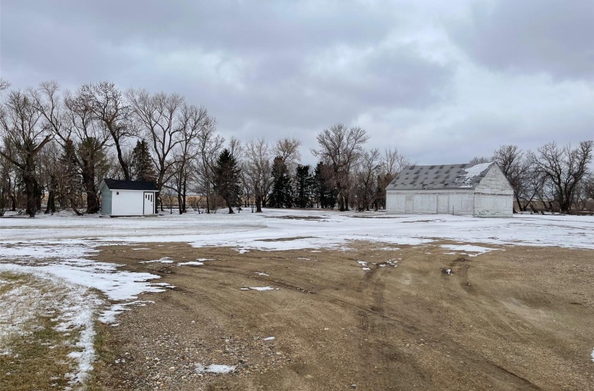 Snowy yard with a storage shed