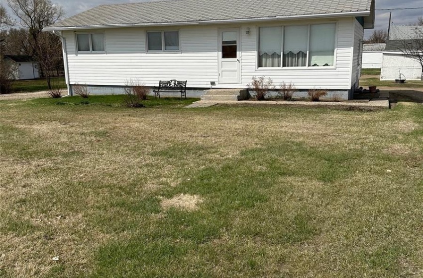 Back of property with a lawn