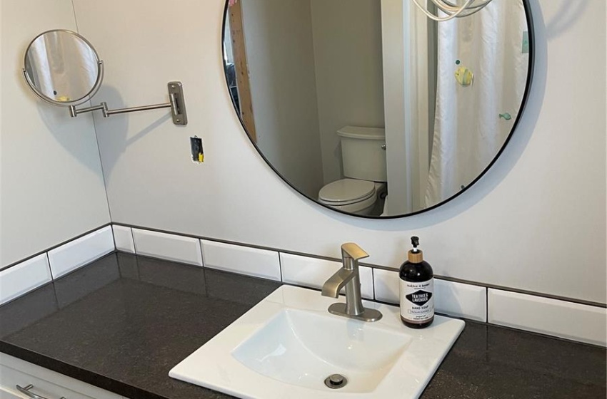 Bathroom featuring toilet and vanity with extensive cabinet space