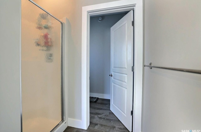 Bathroom with a shower with door and hardwood / wood-style floors