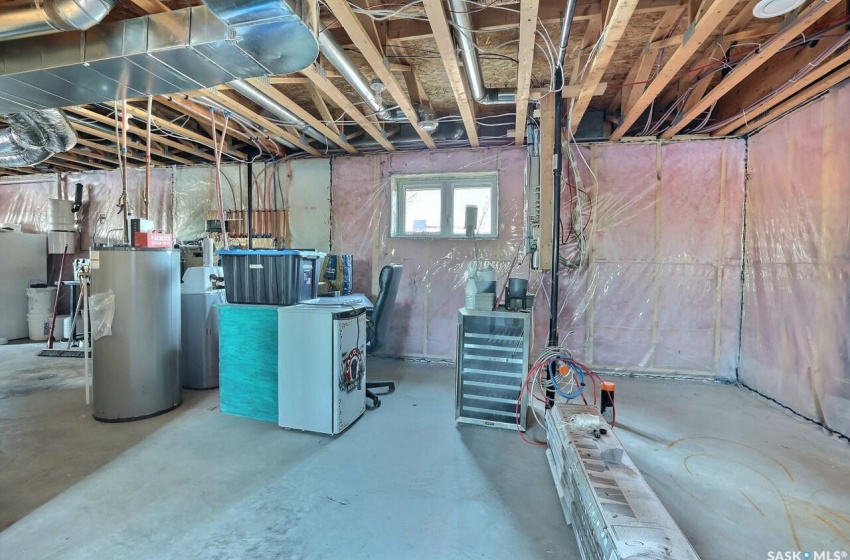 Basement with gas water heater and separate washer and dryer