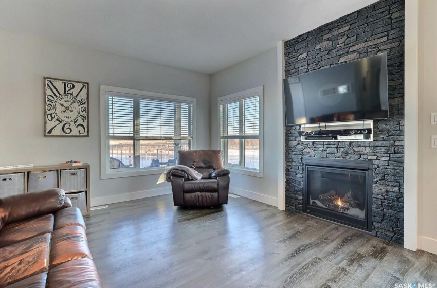 Living room with light hardwood / wood-style floors and a fireplace