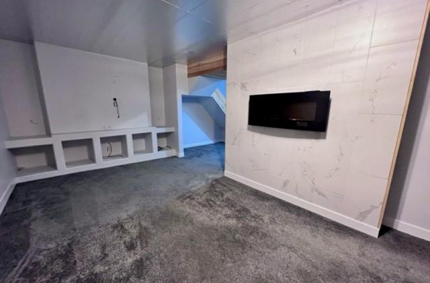 Basement with dark colored carpet