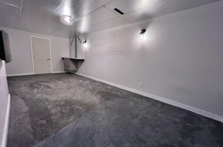 Basement with dark colored carpet