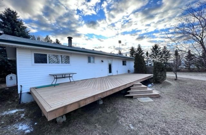 Back of property with a deck