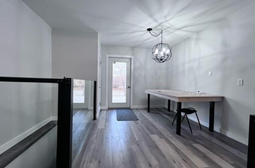 Entrance foyer featuring a notable chandelier and dark wood-type flooring