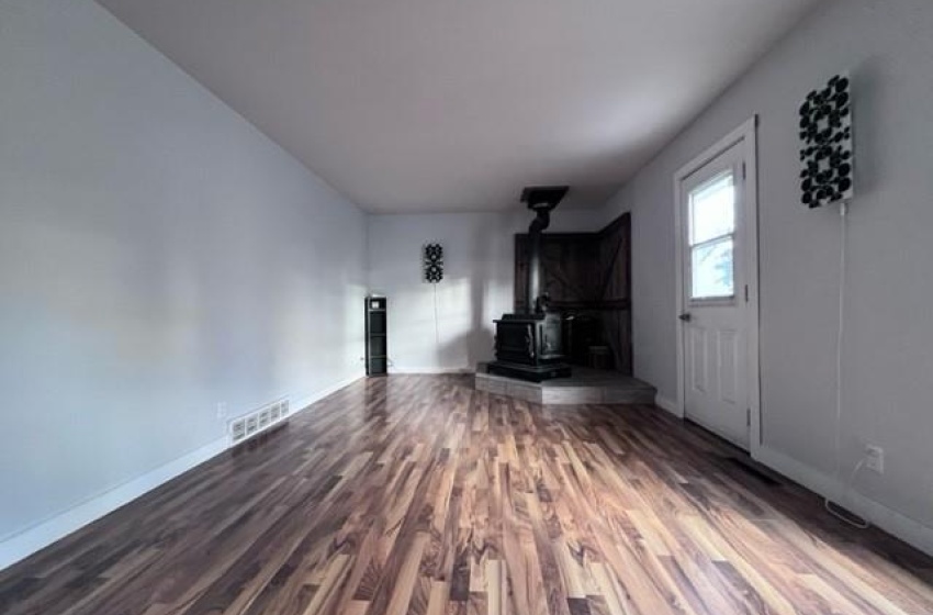 living room featuring a wood stove and dark hardwood / wood-style flooring