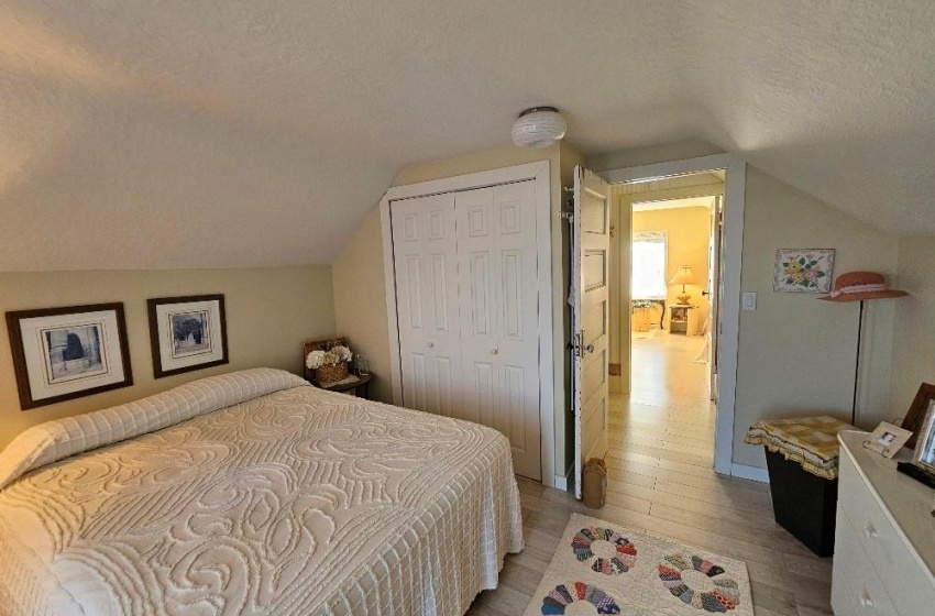 Bedroom with lofted ceiling, and closet.