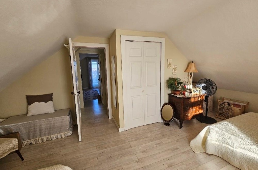 Bedroom with lofted ceiling.