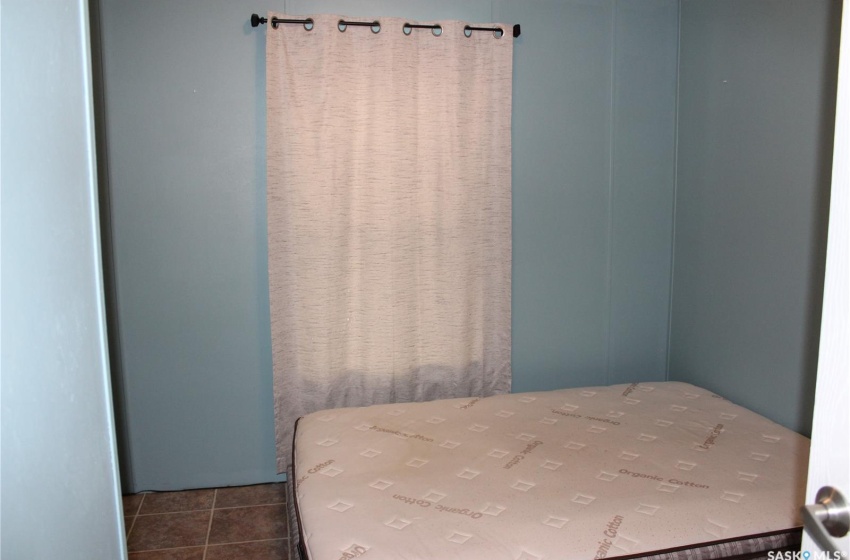 Bedroom with dark tile floors