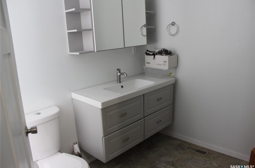 Bathroom with toilet, tile floors, and large vanity