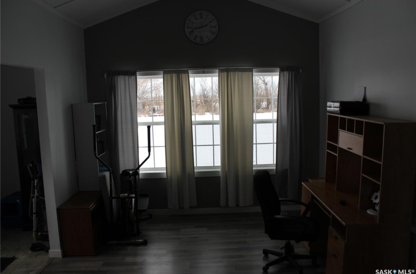 Office area featuring dark hardwood / wood-style flooring and lofted ceiling