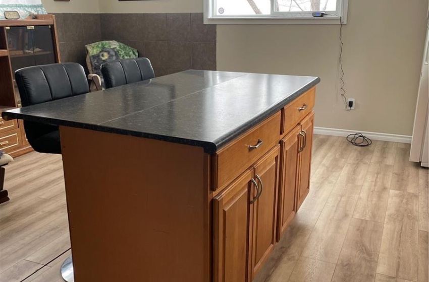 Kitchen with a kitchen island,, a breakfast bar, and a healthy amount of sunlight