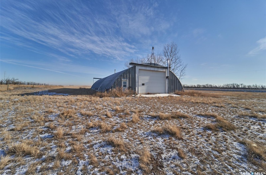 View of yard with a garage and a rural view