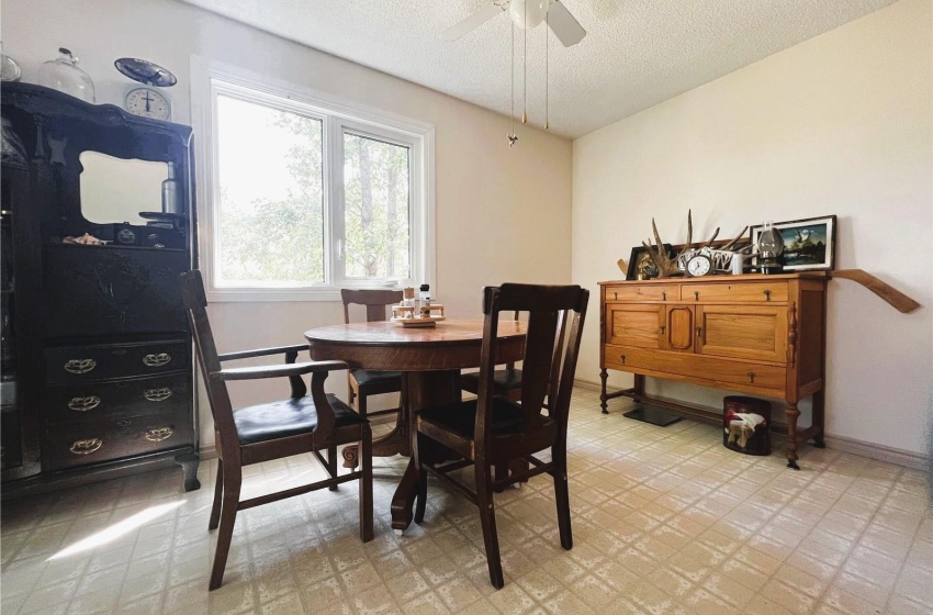 Dining space featuring, a textured ceiling, and ceiling fan