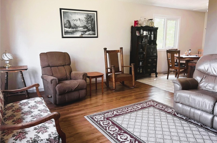 Living room with a textured ceiling and dark hardwood / wood-style floors