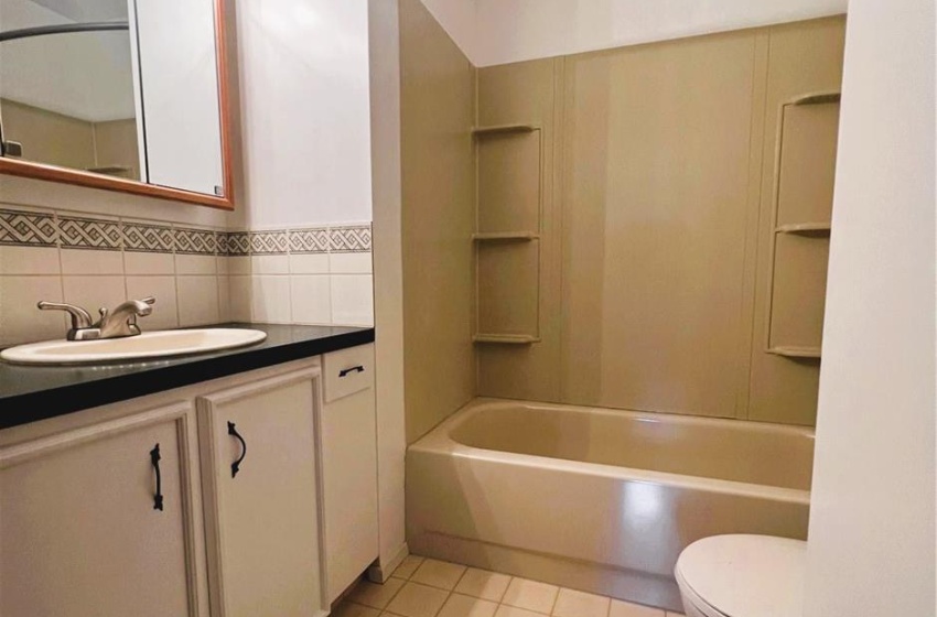 Full bathroom featuring oversized vanity, shower / bathing tub combination, toilet, backsplash