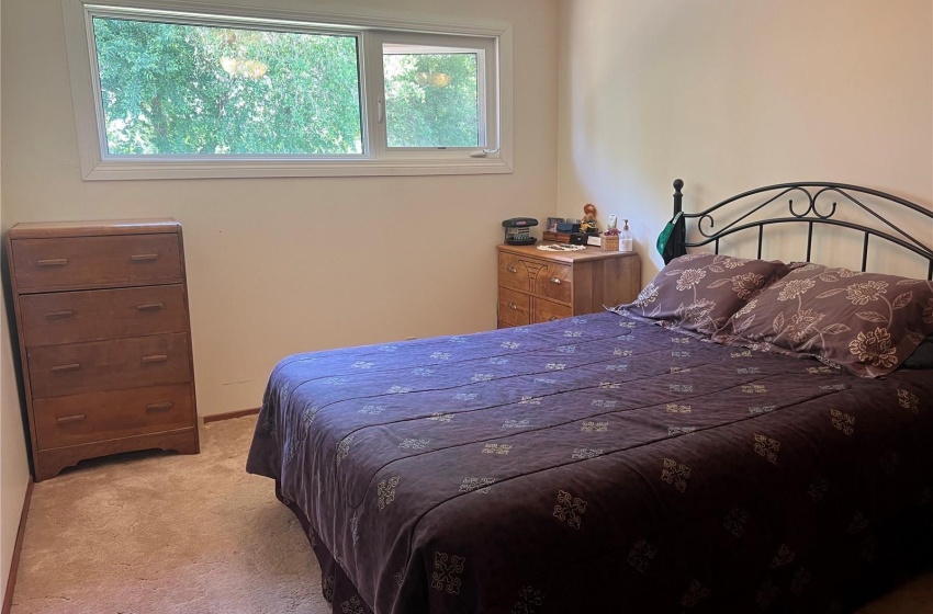 Bedroom with light colored carpet