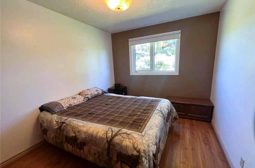 Bedroom featuring wood-type flooring and a textured ceiling