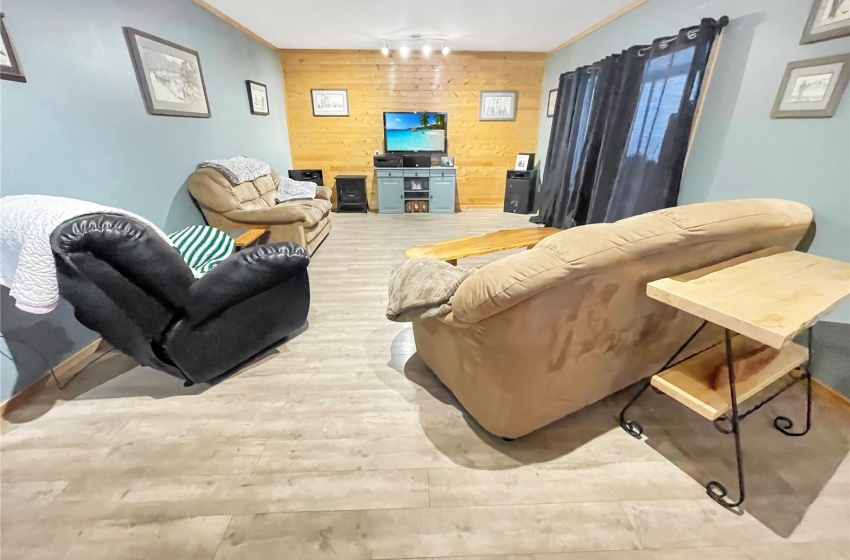 Main floor living room with updated flooring and crown molding