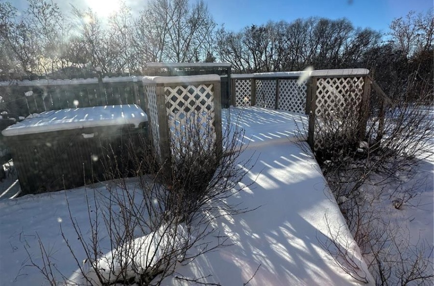 Large deck/sitting area around hot tub overlooking back yard