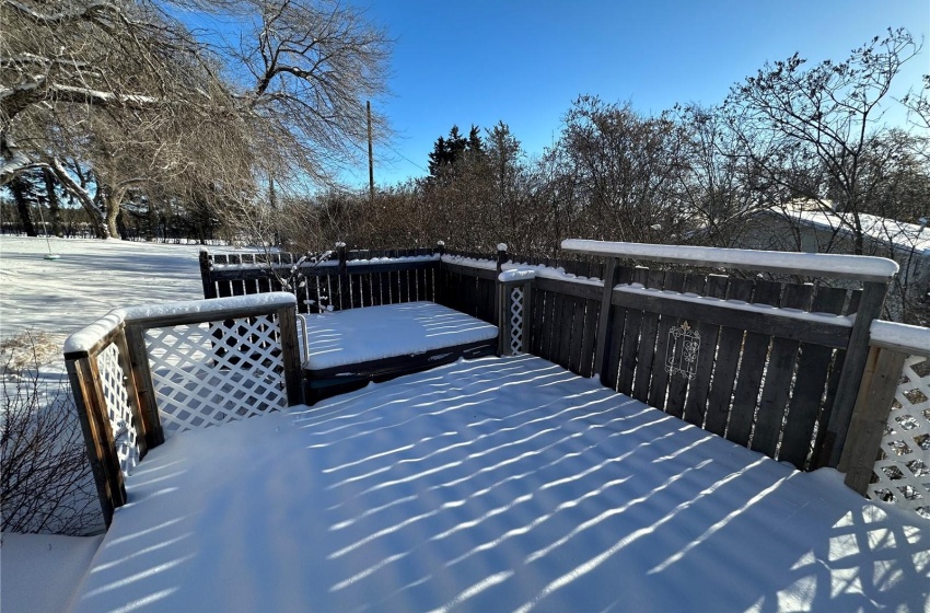 Lovely backyard hot tub area with huge deck overlooking both front and back yards.