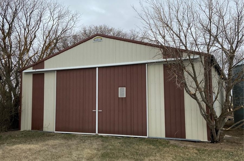 View of outdoor structure featuring a yard