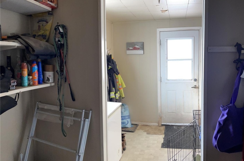 Clothes washing area featuring light tile floors