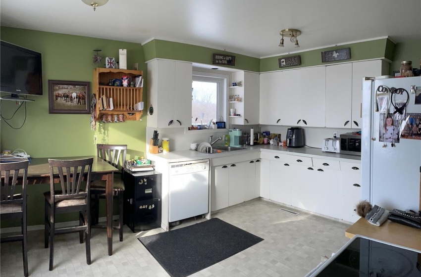 Kitchen featuring white cabinetry, white appliances, and light tile floors