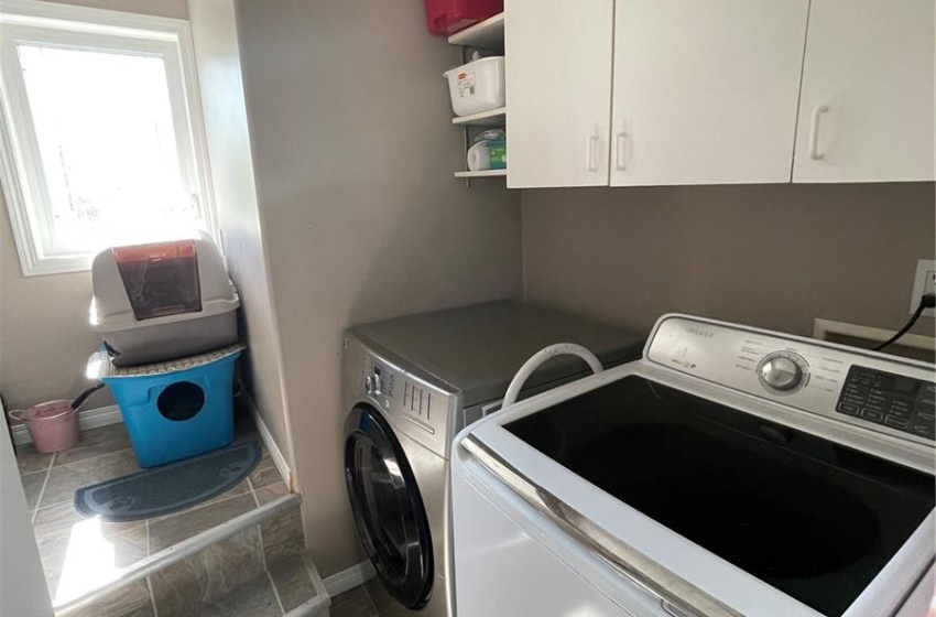 Main floor laundry room with storage