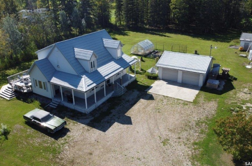 Detached 2 car garage plus large deck out the dining and a wrap around covered deck.