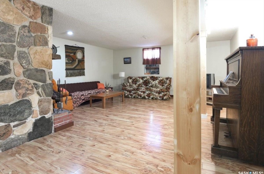 Living room with light wood-type flooring and a textured ceiling