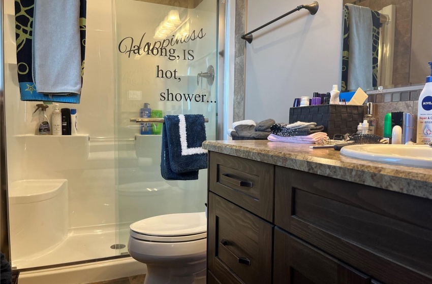 Master Bathroom featuring backsplash, oversized vanity, walk in shower, toilet.