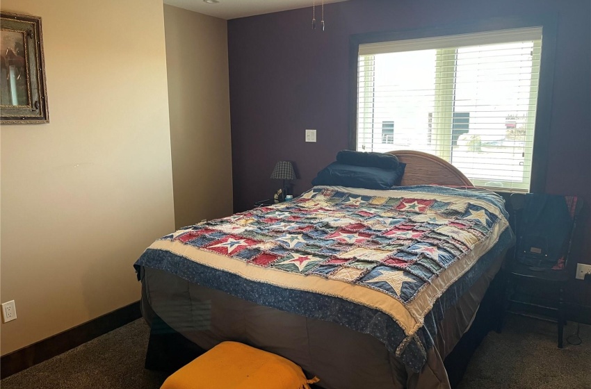 Primary Bedroom featuring dark carpet and ceiling fan