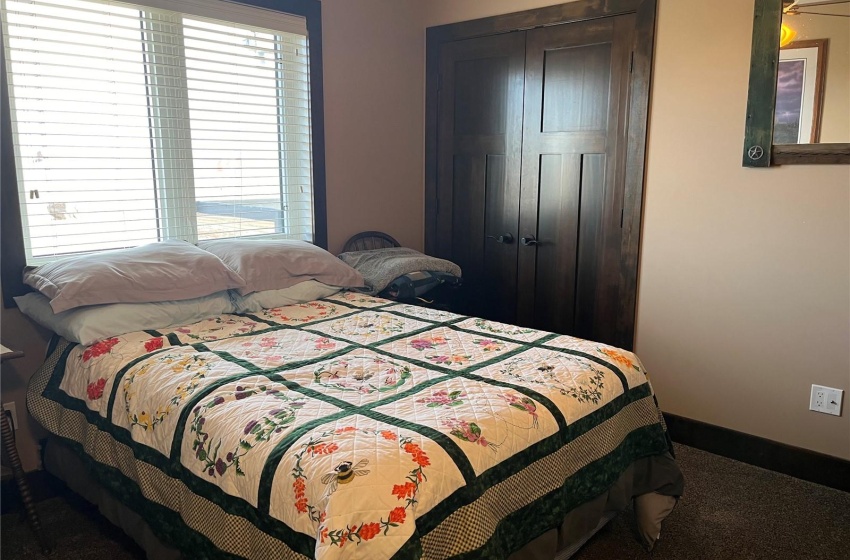 Bedroom with dark carpet and a closet