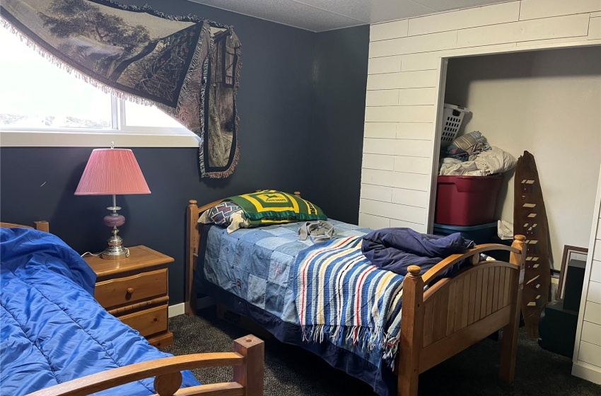 Bedroom featuring dark carpet and a paneled ceiling