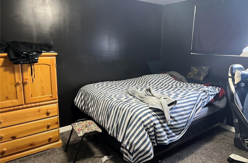 Bedroom featuring dark colored carpet